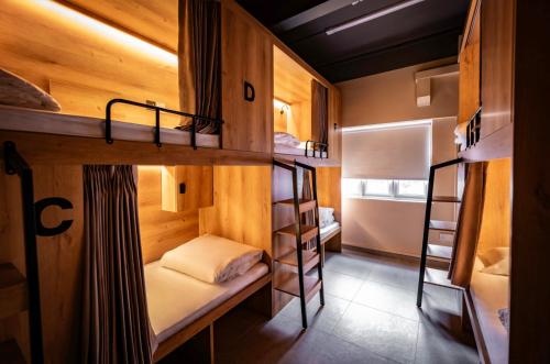 a small room with two bunk beds in it at GUSTI Backpackers Capsule Hostel Singapore in Singapore
