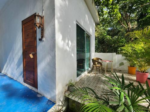 a house with a door and a table and chairs at Easy Life Koh Chang in Ko Chang