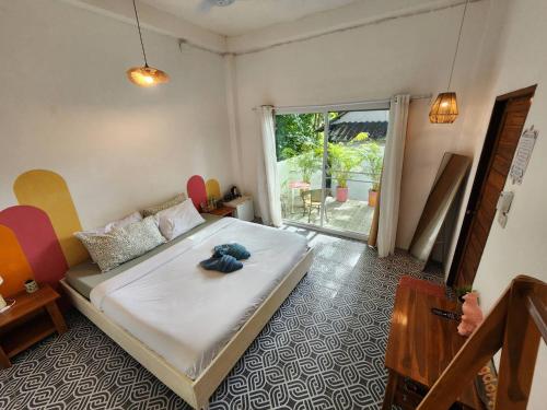a bedroom with a bed and a large window at Easy Life Koh Chang in Ko Chang