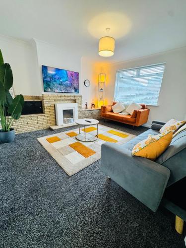 a living room with a couch and a fireplace at Swanky Dudley Retreat in Dudley