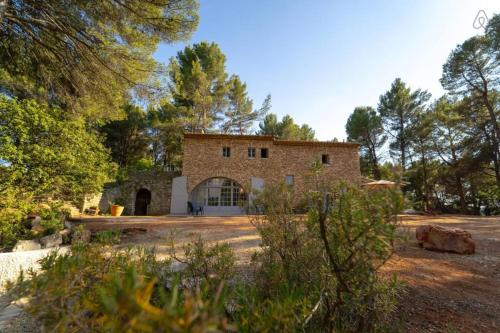 an old brick house in the middle of a field at Stunning panoramic views and heated pool in Roussillon in Roussillon