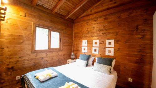 a bedroom with a bed in a wooden room at Casa Margarida, Quinta Carmo - Alcobaça - Nazaré in Alcobaça