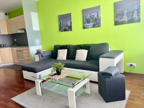a living room with a couch and a table at Three towers with parking in Bratislava