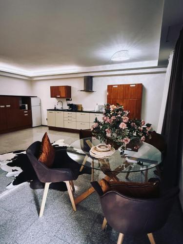 a living room with a glass table and chairs at Koliba 22 in Bratislava