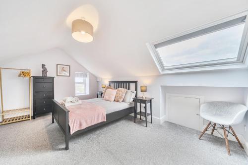 a bedroom with a bed and a window at Ty Mawr, Great Orme in Llandudno