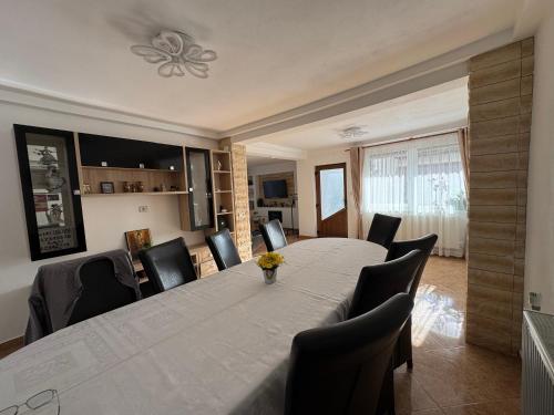 a dining room with a large table and chairs at Casa Luțea in Moieciu de Jos