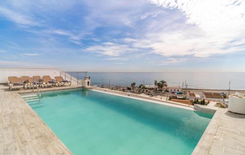 a swimming pool with a view of the ocean at Cozy Home In Torrox Costa in Torrox Costa
