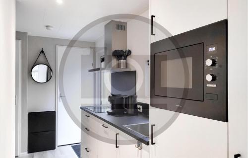 a kitchen with a coffee maker in a glass case at Stunning Home In Vinkeveen With Sauna in Vinkeveen