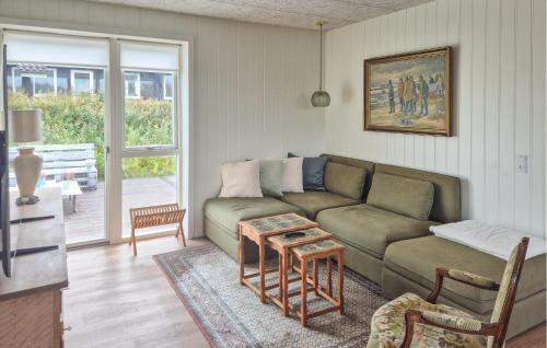 a living room with a couch and a table at 3 Bedroom Beautiful Home In Hurup Thy in Doverodde