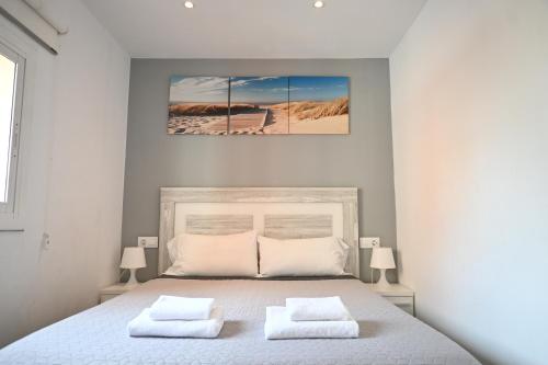 a bedroom with a bed with two white pillows at Homenfun Barcelona Camp Nou in Hospitalet de Llobregat