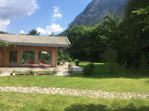 een huis met een patio en een tafel en stoelen bij Achberghütte in Unken