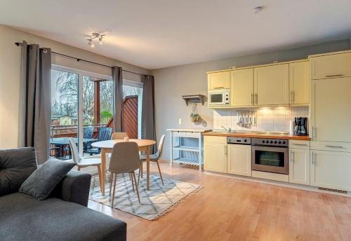 a living room with a kitchen and a dining room at Fewo Melli in Zempin