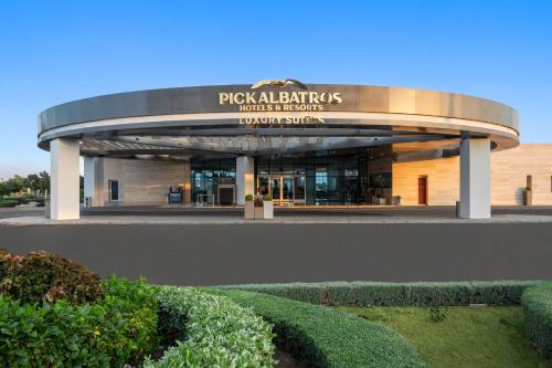 a building with a sign on the front of it at Pickalbatros Golf Luxury Suites - All Inclusive in Sharm El Sheikh
