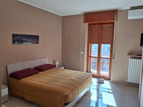 a bedroom with a bed and a large window at B&B Dolce Riposo in Foggia