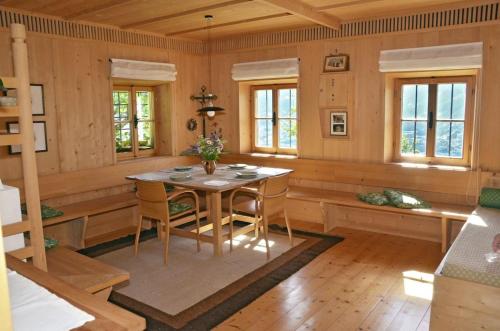 a dining room with a table and chairs at Kohlstatt Hütte in Verano
