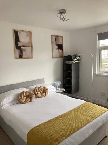 a bedroom with a large bed with a yellow blanket at The Spacious Stay Stratford in London