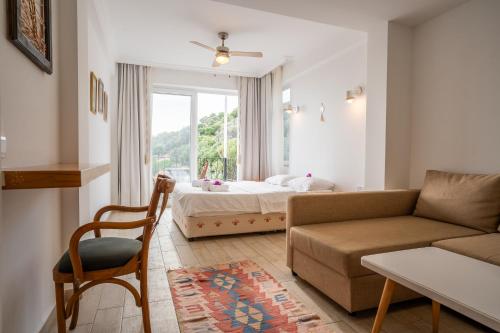 a living room with a bed and a couch at Hideaway in Kas