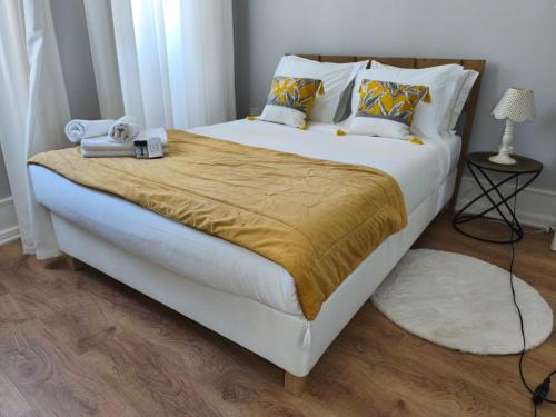 a bedroom with a large bed with a teddy bear on it at Mourisca 1810 Guest House in Águeda