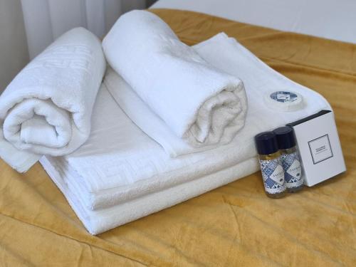 a pile of towels sitting on top of a table at Mourisca 1810 Guest House in Águeda