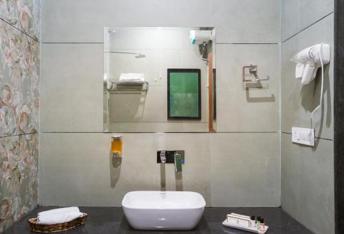 a bathroom with a toilet and a mirror at Shreeji Desert Resort in Sām