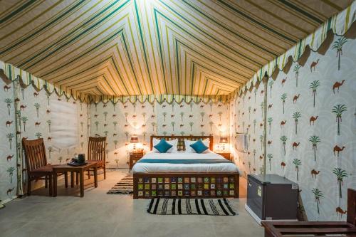 a bedroom with a bed in a room at Shreeji Desert Resort in Sām
