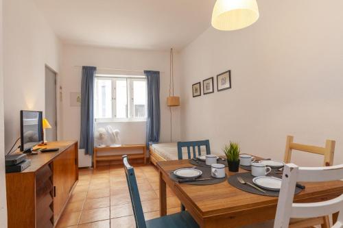a living room with a table and a dining room at B94 - Casa dos Peixeiros in Lagos in Lagos