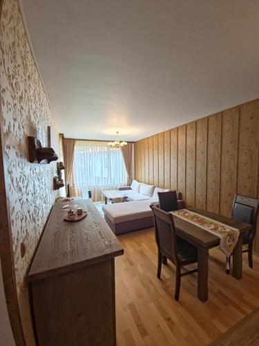 a living room with a bed and a couch at Апартамент Орфинда- Pamporovo in Pamporovo