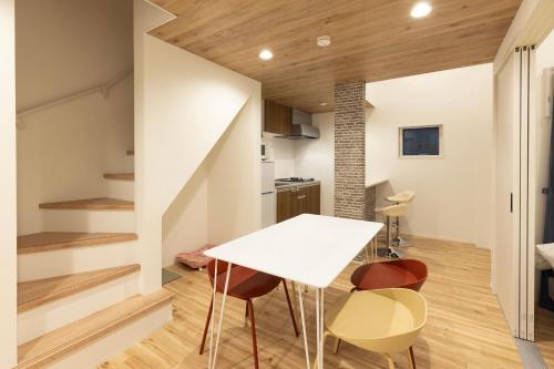 a kitchen and dining room with a white table and chairs at Hotel Star Residence 3 WEST in Fukuoka