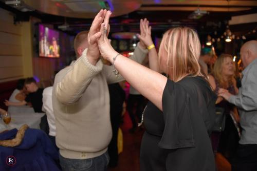 two people standing on a dance floor with their hands up at Casuarina Tree in London