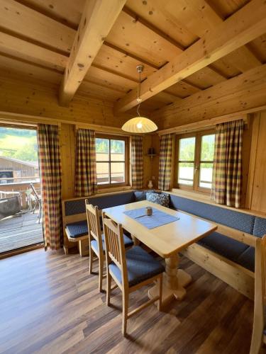 a dining room with a wooden table and chairs at Chalet Amade in Forstau