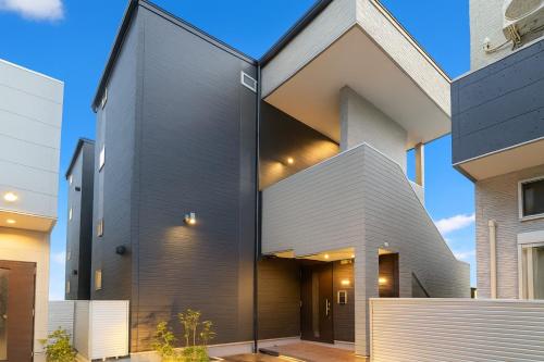 a modern house with a black and white facade at Hotel Star Residence 3 WEST in Fukuoka