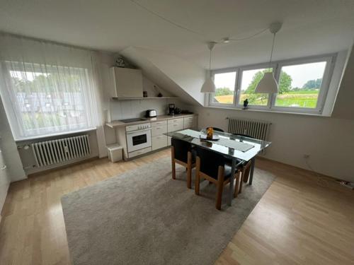 a kitchen with a table and chairs in a room at Oberdorf in Konstanz