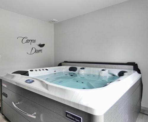 a jacuzzi tub in the corner of a room at L'HACIENDA DUO a romantic getaway with a private spa in Charavines