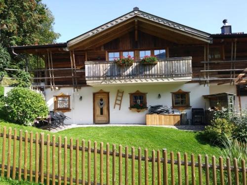 a house with a fence in front of it at Almchalet Schneeberg in Mühlbach am Hochkönig