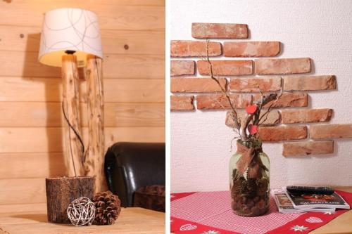 a vase with flowers on a table next to a brick wall at Almchalet Schneeberg in Mühlbach am Hochkönig