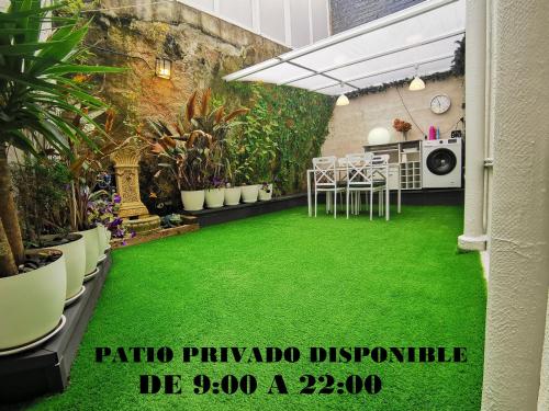 a garden with a green floor in a room at Villa Playa Baiona in Baiona