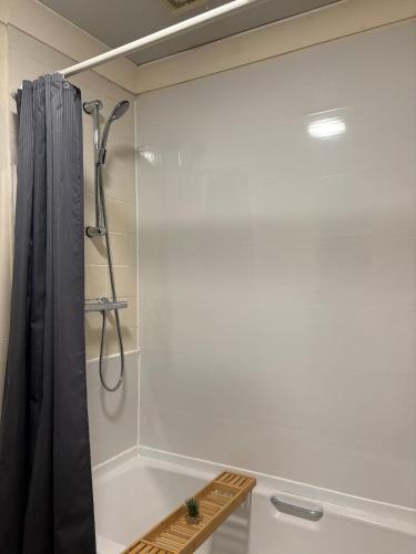 a bathroom with a shower with a shower curtain at Manchester G Escape in Manchester