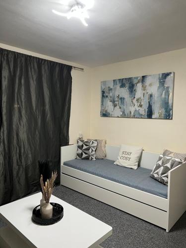 a living room with a couch with pillows on it at Manchester G Escape in Manchester