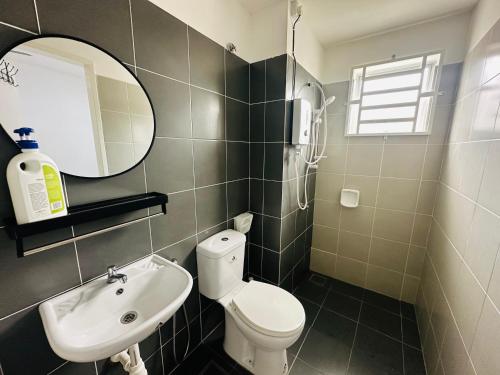 a bathroom with a toilet and a sink and a mirror at Mahligai Haza 2- Gambang in Gambang