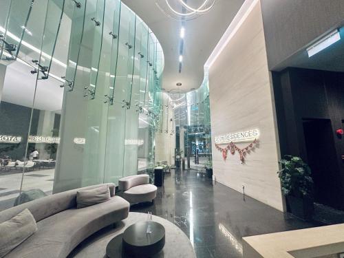 a lobby with a couch and chairs in a building at Eaton Delight Residences in Kuala Lumpur