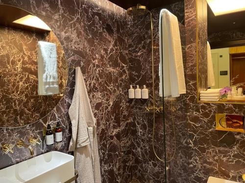 a bathroom with a sink and a shower at Four Suites Copenhagen in Copenhagen