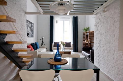 a living room with a table and chairs at GoToSeville FERIA APARTMENTS in Seville