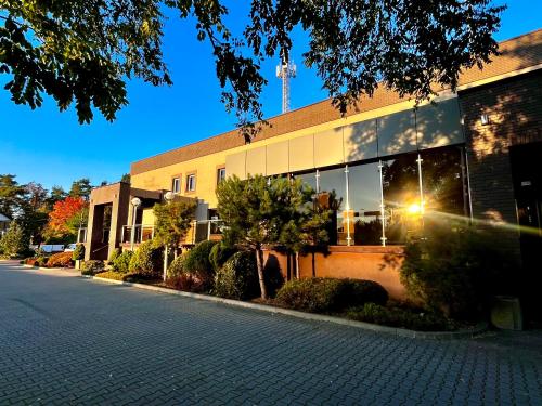 a building with a street in front of it at Przystanek Słupno, 5 km od Płock in Słupno