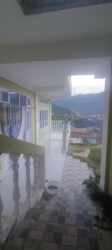a view of a balcony of a house with a window at Green Tara Homestay in Dirang Dzong