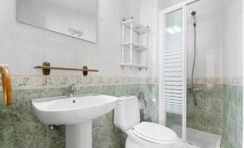 a bathroom with a toilet and a sink at wonderful tila house, facing the sea in La Garita