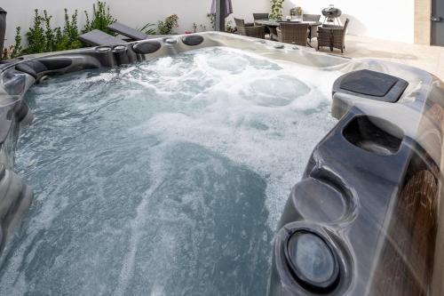 a jacuzzi tub with snow and ice on it at Granite cottage in Isle of Jersey