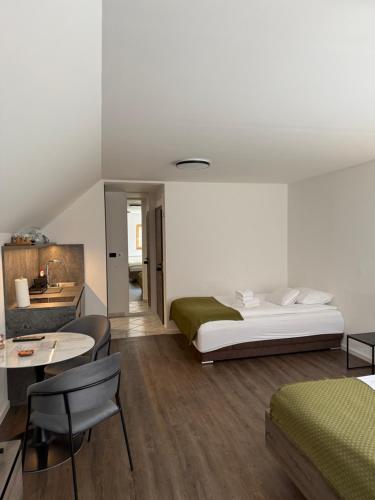a bedroom with a bed and a table and chairs at 4 Elements Glamping & Apartments in Bled