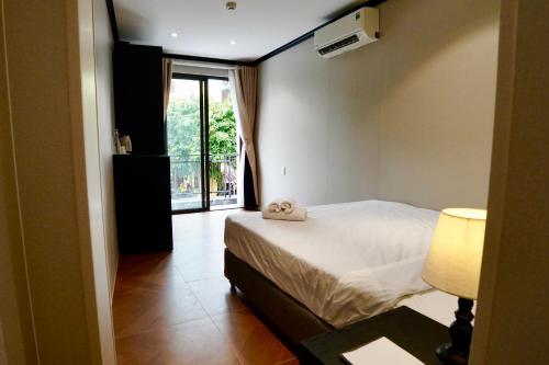 a bedroom with a bed with a towel on it at HY Local Budget Hotel - 5 mins walk to Hoi An Ancient Town in Hoi An