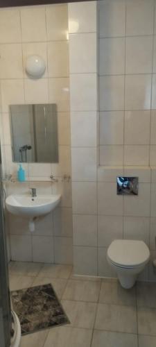 a bathroom with a toilet and a sink at Hotel Marko 2 Warszawa in Warsaw