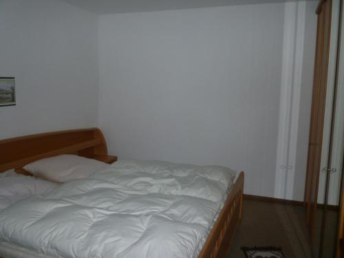 a bedroom with a bed with white sheets at Alte Kirchstraße in Willingen